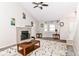 Bright living room featuring a fireplace, ceiling fan, and large area rug at 11612 E 75Th St, Indianapolis, IN 46236
