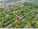 Aerial view of a home nestled in a neighborhood with mature trees and a pool nearby at 11807 Rolling Springs Dr, Carmel, IN 46033