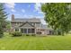 Expansive backyard featuring a well-manicured lawn, mature trees, and an inviting patio for outdoor enjoyment at 11807 Rolling Springs Dr, Carmel, IN 46033