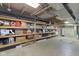 Unfinished basement storage area with exposed ceiling and an abundance of shelving at 11807 Rolling Springs Dr, Carmel, IN 46033