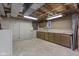 Unfinished basement with painted cement block walls and unfinished ceiling, with built in work bench and cabinets at 11807 Rolling Springs Dr, Carmel, IN 46033