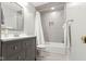 Well-lit bathroom with gray vanity, shower with white curtain, and neutral tile at 11807 Rolling Springs Dr, Carmel, IN 46033