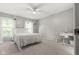 Bright bedroom featuring neutral walls, carpet, a ceiling fan, and natural light through large windows at 11807 Rolling Springs Dr, Carmel, IN 46033