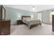 Spacious bedroom with soft carpet, ceiling fan, natural light, and neutral paint color at 11807 Rolling Springs Dr, Carmel, IN 46033