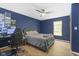 Blue bedroom with hardwood flooring and a ceiling fan with integrated lighting at 11807 Rolling Springs Dr, Carmel, IN 46033