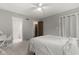 Neutral bedroom with a ceiling fan, soft carpet, and ensuite access to the bathroom at 11807 Rolling Springs Dr, Carmel, IN 46033