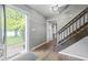 Spacious foyer with hardwood floors and staircase leading to a bright, open living space at 11807 Rolling Springs Dr, Carmel, IN 46033