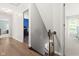 Bright hallway features hardwood floors and entrances to bedrooms at 11807 Rolling Springs Dr, Carmel, IN 46033