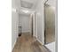Bright hallway with wood flooring, multiple doorways, and convenient access to different areas at 11807 Rolling Springs Dr, Carmel, IN 46033