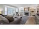 Comfortable living room with fireplace, built-in shelves, hardwood floors, and large windows with natural light at 11807 Rolling Springs Dr, Carmel, IN 46033