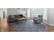 Cozy living room features a comfortable sofa, chair, rustic coffee table, and patterned area rug at 11807 Rolling Springs Dr, Carmel, IN 46033