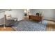 Inviting home office with hardwood floors, area rug, classic wooden desk, and comfortable chair at 11807 Rolling Springs Dr, Carmel, IN 46033