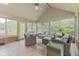 Bright sunroom with comfortable seating, tile flooring, and serene views of the backyard at 11807 Rolling Springs Dr, Carmel, IN 46033