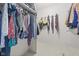 Well-organized walk-in closet with hanging clothes, bags, and shelving for optimal storage at 11807 Rolling Springs Dr, Carmel, IN 46033