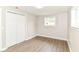 Bedroom featuring wood-look floors, closet, and natural light at 12029 Meadow Ln, Indianapolis, IN 46236