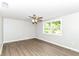 Bright bedroom with neutral walls, wood-look flooring, and large picture window at 12029 Meadow Ln, Indianapolis, IN 46236
