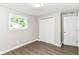 Bedroom featuring wood-look flooring, closet, and natural light at 12029 Meadow Ln, Indianapolis, IN 46236