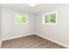 Bright bedroom with wood-look floors and dual windows at 12029 Meadow Ln, Indianapolis, IN 46236