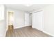 Bedroom featuring wood-look floors, closet, and attached bathroom at 12029 Meadow Ln, Indianapolis, IN 46236