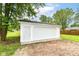 Detached garage with painted white siding and brick driveway at 12029 Meadow Ln, Indianapolis, IN 46236