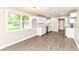 Eat-in kitchen featuring white cabinetry, stainless steel appliances, and wood-look flooring at 12029 Meadow Ln, Indianapolis, IN 46236