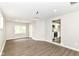 Open-concept living area with wood-look floors and view into updated kitchen at 12029 Meadow Ln, Indianapolis, IN 46236