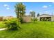 Lush backyard with mature trees, a shed for storage, and a detached garage at 1211 W 10Th St, Muncie, IN 47302