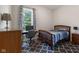 Inviting bedroom featuring a classic bed, an area rug, and a well-lit workspace for a serene atmosphere at 1211 W 10Th St, Muncie, IN 47302