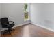 Featuring new, warm-toned laminate flooring, this spacious room offers plenty of natural light and flexible arrangement at 1211 W 10Th St, Muncie, IN 47302