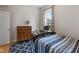 Cozy bedroom featuring a bed with a patterned rug, a dresser, and ample natural light at 1211 W 10Th St, Muncie, IN 47302