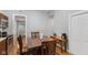 Cozy dining area features a wooden table set and flows seamlessly into the kitchen, with warm hardwood floors throughout at 1211 W 10Th St, Muncie, IN 47302
