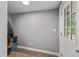 Functional entryway with a white door, practical storage solutions, and a neutral color scheme at 1211 W 10Th St, Muncie, IN 47302
