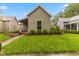Charming home featuring a well-manicured lawn, complemented by neat shrubbery and a quaint, covered porch entry at 1211 W 10Th St, Muncie, IN 47302
