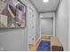 Inviting hallway with hardwood floors, an artistic print, and a cozy bench, leading to various rooms at 1211 W 10Th St, Muncie, IN 47302
