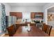 A well-lit kitchen featuring wooden cabinetry, stainless steel appliances, and a spacious dining area at 1211 W 10Th St, Muncie, IN 47302