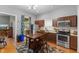 A fully-equipped kitchen showcasing wood cabinets, stainless steel appliances, and an adjacent dining space at 1211 W 10Th St, Muncie, IN 47302