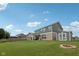 Exterior view of home featuring an expansive backyard, storage shed, and inviting covered patio for outdoor enjoyment at 13163 N Departure W Blvd, Camby, IN 46113