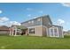 Lush backyard with a well-maintained lawn, storage shed, and cozy covered patio, ideal for outdoor relaxation and entertainment at 13163 N Departure W Blvd, Camby, IN 46113