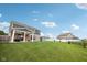 Expansive backyard with a covered patio, lush lawn, storage shed, and charming architectural home design at 13163 N Departure W Blvd, Camby, IN 46113