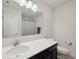 Clean bathroom with modern features including a white countertop, dark cabinetry, and a shower with a striped curtain at 13163 N Departure W Blvd, Camby, IN 46113