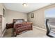 Comfortable bedroom with wood bed frame, neutral carpeting, and natural light streaming in through window and gray office chair at 13163 N Departure W Blvd, Camby, IN 46113