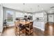 Dining area with wood table, chandelier lighting, and access to the kitchen with granite countertops at 13163 N Departure W Blvd, Camby, IN 46113