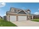 Beautiful two-story home with a three-car garage and well-maintained lawn at 13163 N Departure W Blvd, Camby, IN 46113