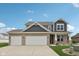 Charming two-story home with brick and siding exterior and a three-car garage at 13163 N Departure W Blvd, Camby, IN 46113