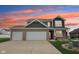 Beautiful two-story home with brick and siding exterior during a colorful sunset at 13163 N Departure W Blvd, Camby, IN 46113