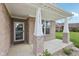 Inviting covered front porch with brick columns and a view of the landscaped yard at 13163 N Departure W Blvd, Camby, IN 46113