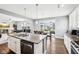 Spacious kitchen with an island, dining area, and modern appliances, leading to an open living space at 13163 N Departure W Blvd, Camby, IN 46113