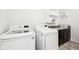 Bright laundry room features modern LG washer and dryer, with sleek countertop, cabinetry, and storage shelves above at 13163 N Departure W Blvd, Camby, IN 46113