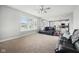 Spacious living room with plush seating and large windows, seamlessly connected to the modern kitchen at 13163 N Departure W Blvd, Camby, IN 46113