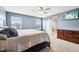 Comfortable main bedroom with a ceiling fan, mounted TV, and a barn door to main bathroom at 13163 N Departure W Blvd, Camby, IN 46113